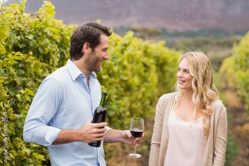 Young happy man offering wine to a young woman © WavebreakMediaMicro