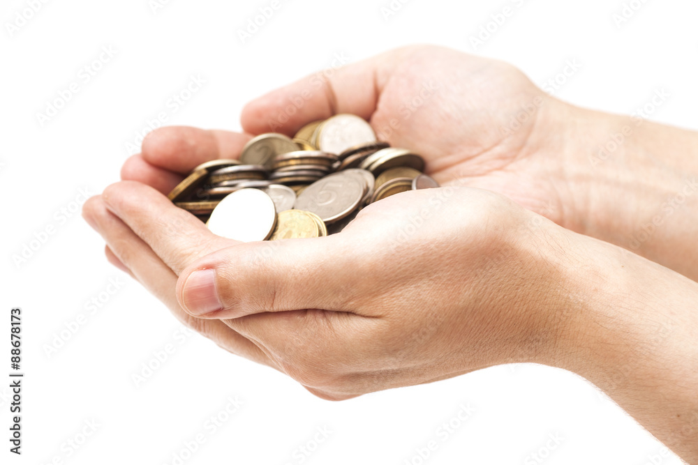 Handful of coins in palm hands isolated on white