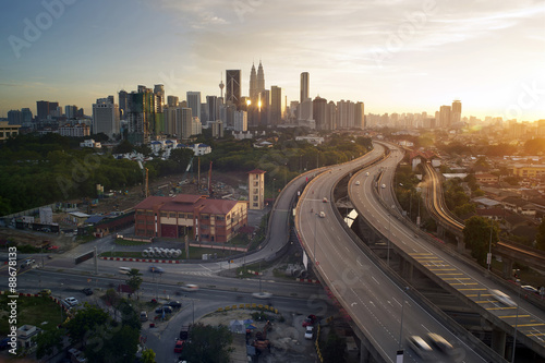 Dramatic scenery of elevated highway heading towards Kuala Lumpur city centre during sunset.