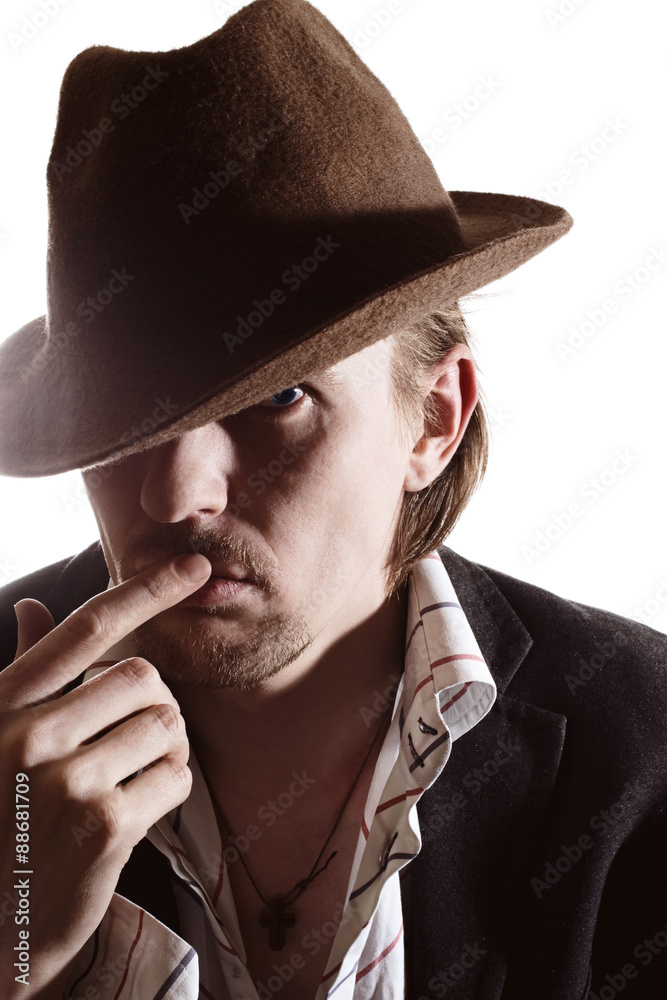 Studio portrait of a young man in a hat Studio portrait of a young man in a hat