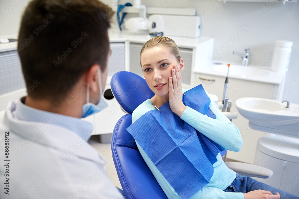 male dentist with woman patient at clinic male dentist with woman patient at clinic