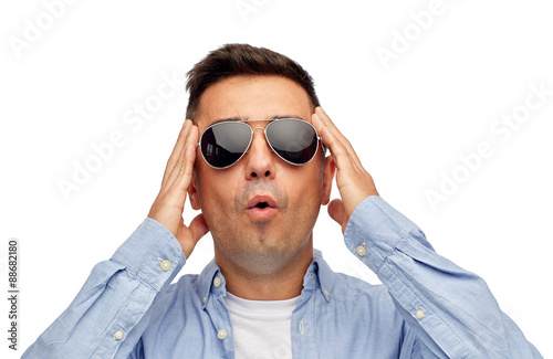 face of scared man in shirt and sunglasses