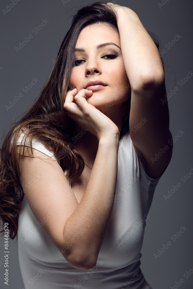 Portrait of pretty young woman posing in the studio photo. Portrait of pretty young woman posing in the studio photo.