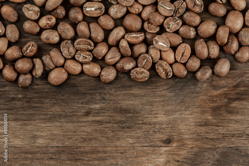Background coffee. Roasted beans on old wooden background