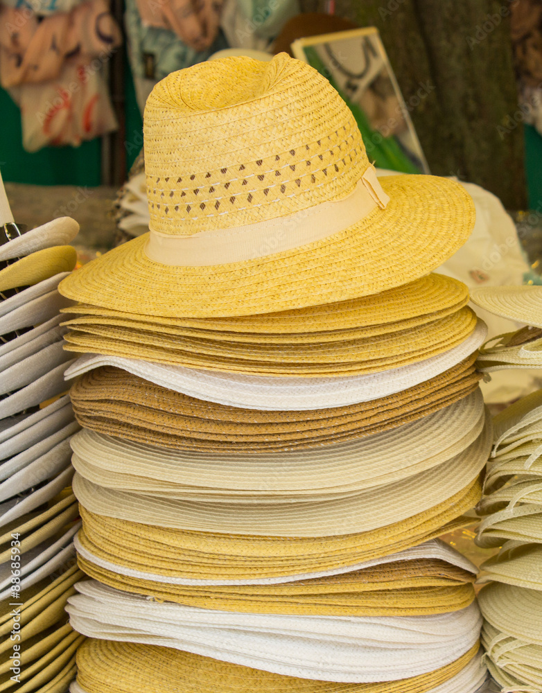 Collection of handmade straw hats on stall