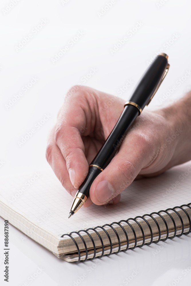 Man writing a note with black ball pen in his hand, isolated Man writing a note with black ball pen in his hand, isolated