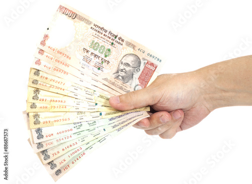 Hand with Indian thousand rupee notes isolated
