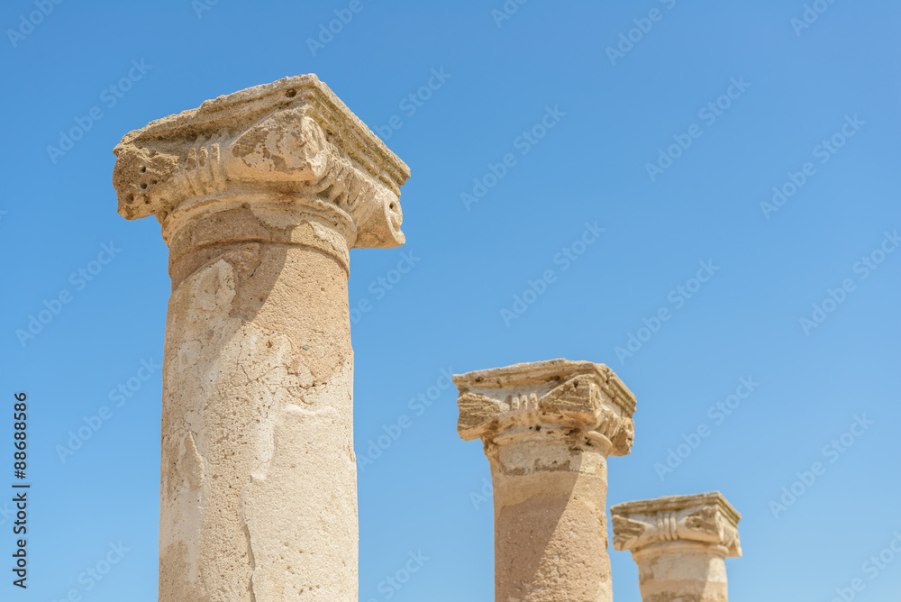 Ancient carved stone columns at an archaeological site in Paphos, Cyprus..