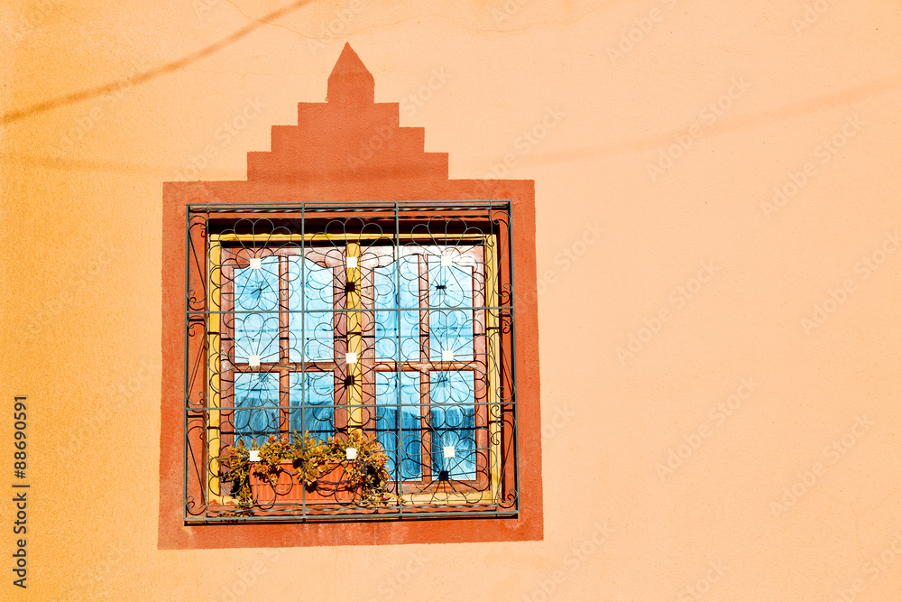 blue window in old  and brown wall  construction