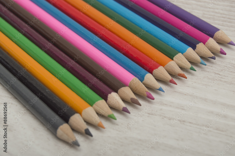 Colored pencils on wood texture. Copyspace in the lower right. Colored pencils on wood texture. Copyspace in the lower right.