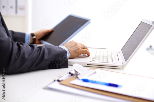 Closeup of a businessman hands typing on a laptop keyboard