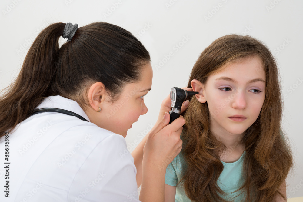 Doctor Examining Patient Ear With Otoscope Doctor Examining Patient Ear With Otoscope