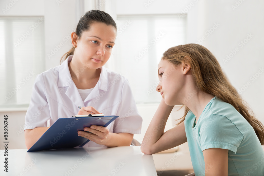 Doctor Comforting Patient At Table Doctor Comforting Patient At Table