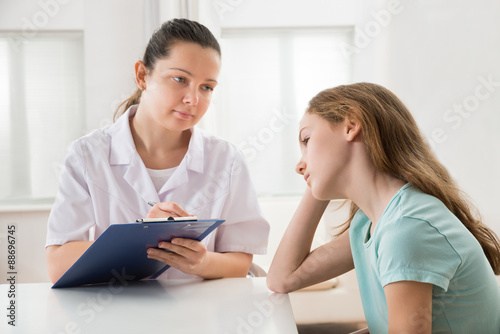 Doctor Comforting Patient At Table