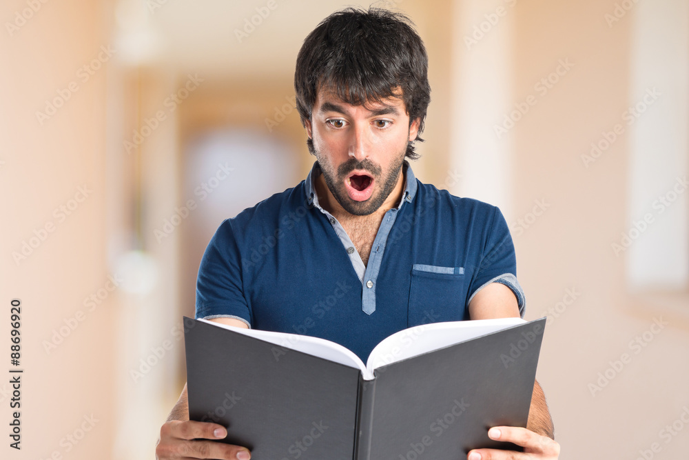 Man reading a book over white background Man reading a book over white background