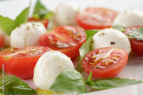 caprese salad with mini mozzarella balls and tomatoes