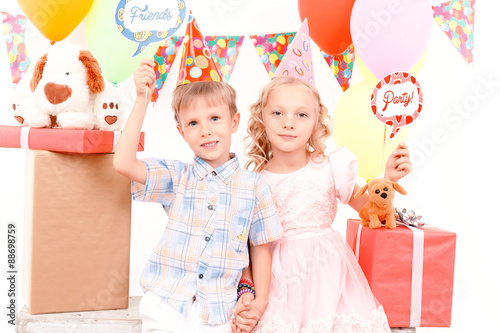 Little boy and girl posing during birthday party 