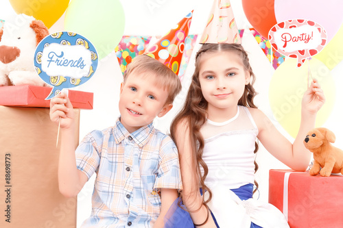Little boy and girl posing during birthday party 
