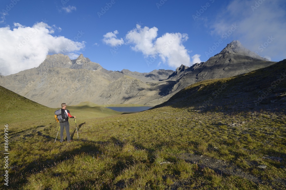 A lone hiker - Col de Lanserlia, 2774 m, Vanoise national park, France A lone hiker - Col de Lanserlia, 2774 m, Vanoise national park, France