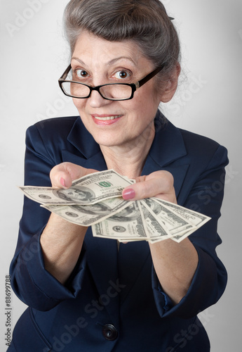 Portrait super happy excited successful senior woman lady holding money dollar bills in hand
