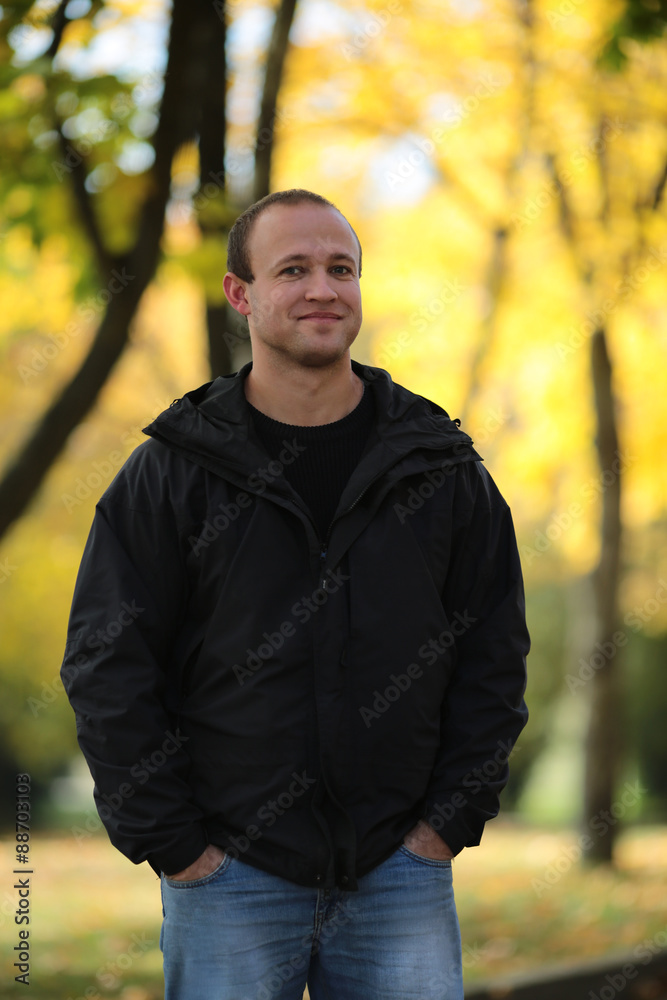 Portrait of the young man on walk on autumn park Portrait of the young man on walk on autumn park