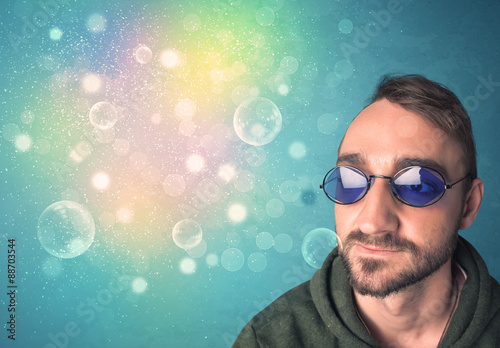 Young man with sunglasses and bokeh colourful lights