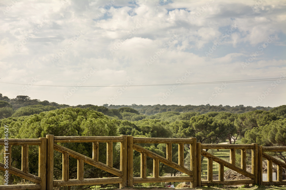 View of the landscape from the wooden railing View of the landscape from the wooden railing