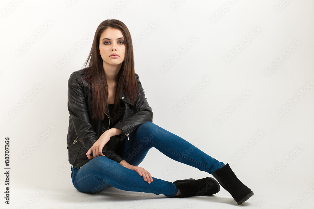 Portrait of sitting young calm beautiful brunette woman posing for model tests against white background Portrait of sitting young calm beautiful brunette woman posing for model tests against white background