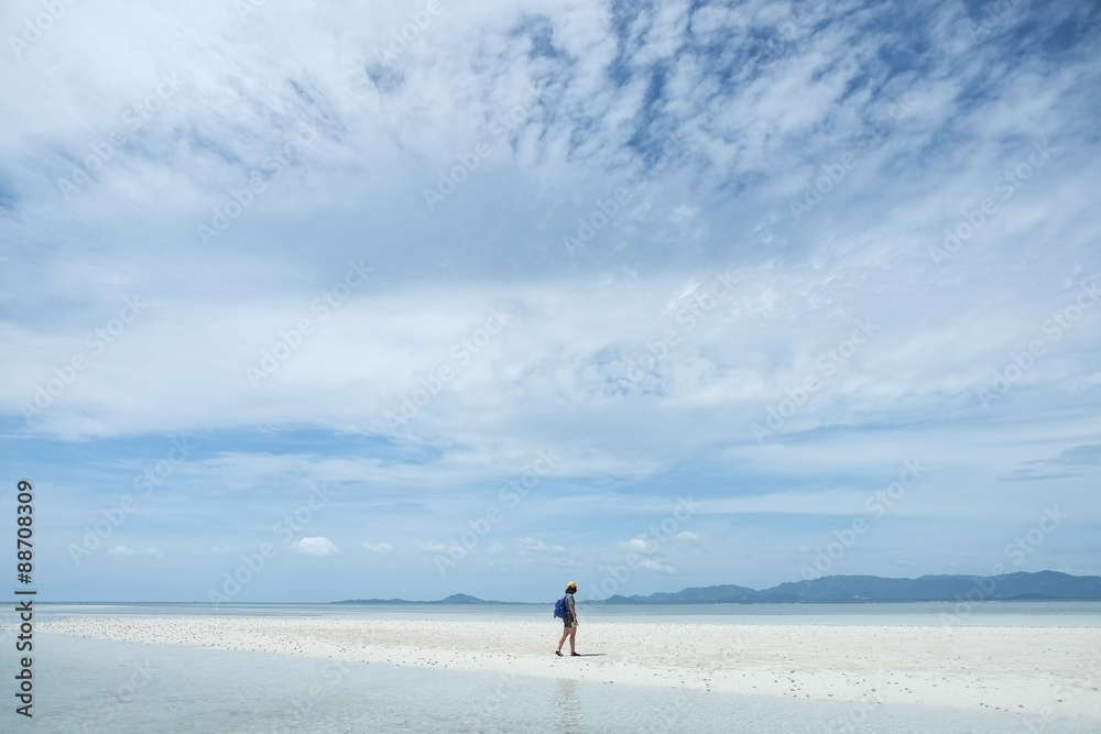 Beach travel - woman walking on sandy beach at Koh Phangan, Southern Thailand