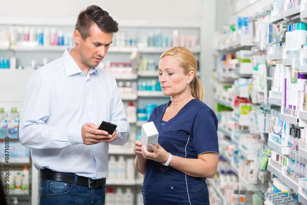 Customer Showing Product Information On Mobile Phone To Pharmaci