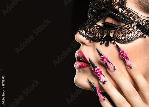 Beautiful girl in mask with long nails and sensual lips. Beauty