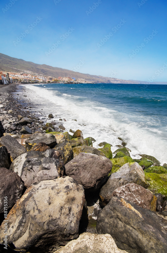 Black sandy beach in famous Candelaria town in Tenerife, Canary Island, Spain. .