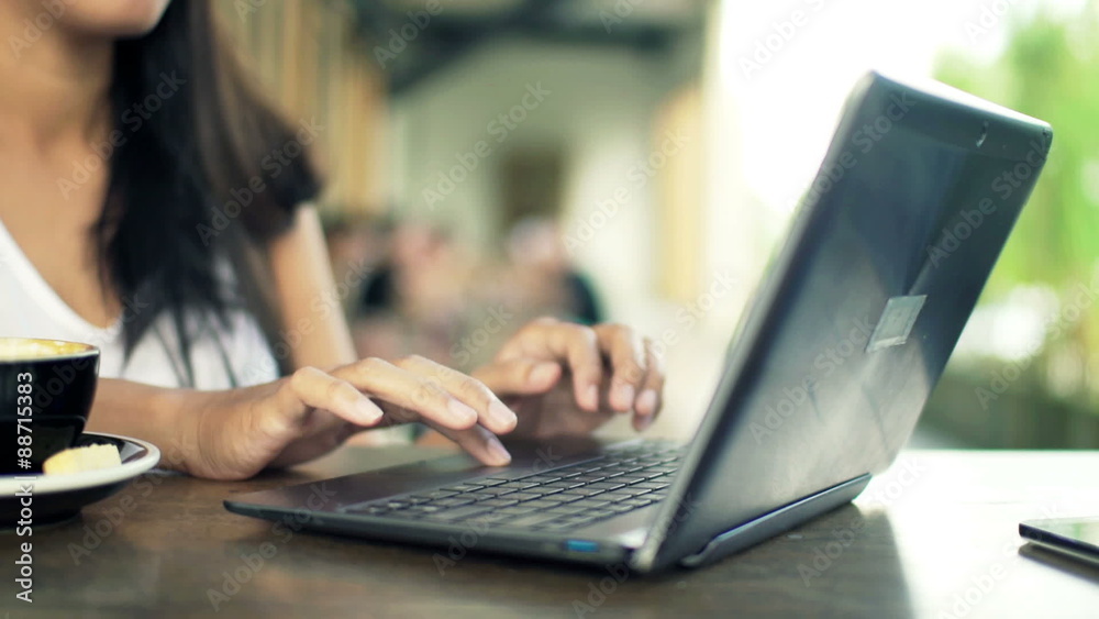 Female student hands using laptop sitting by table in cafe
Female student hands using laptop sitting by table in cafe