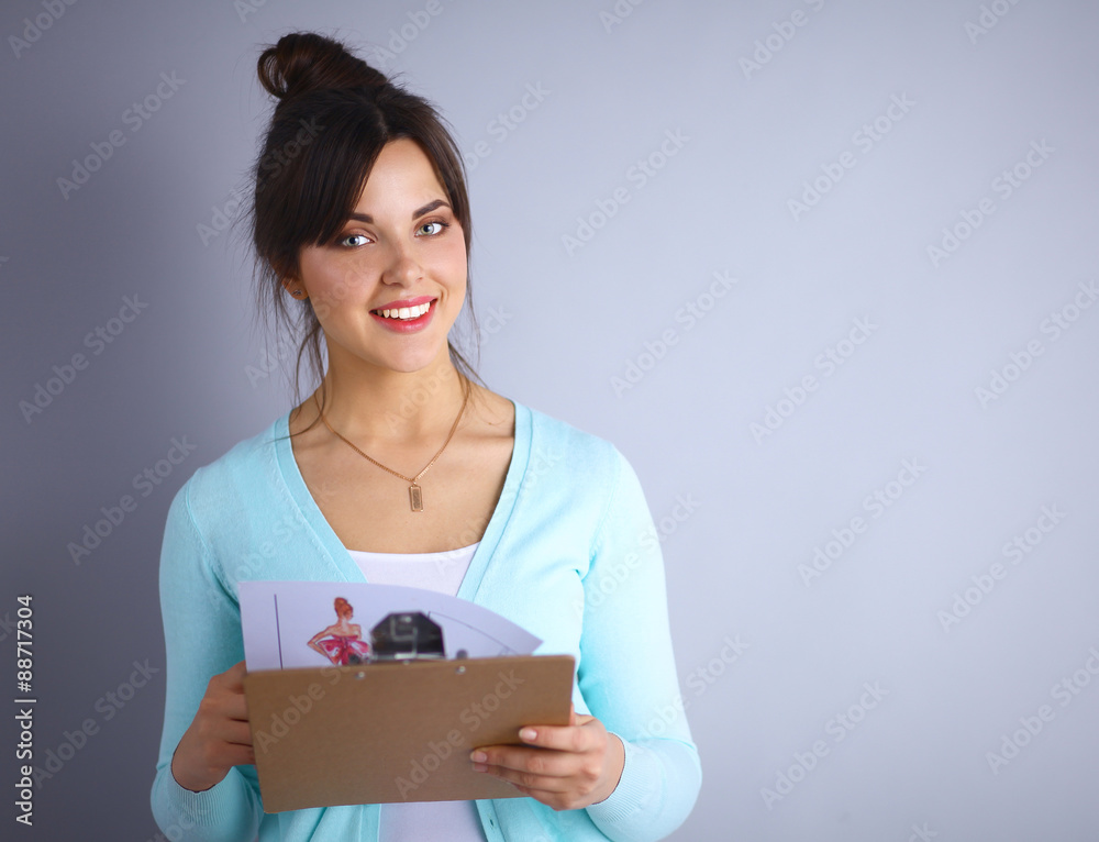 Woman with folder for documents on gray background Woman with folder for documents on gray background