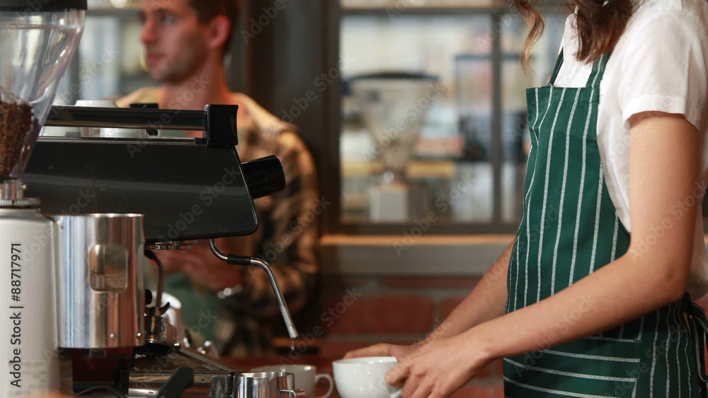 Smiling barista serving a client