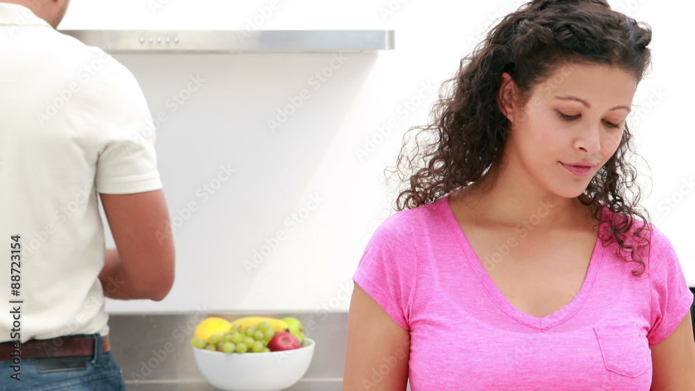 Happy couple cooking together in the kitchen Happy couple cooking together in the kitchen
