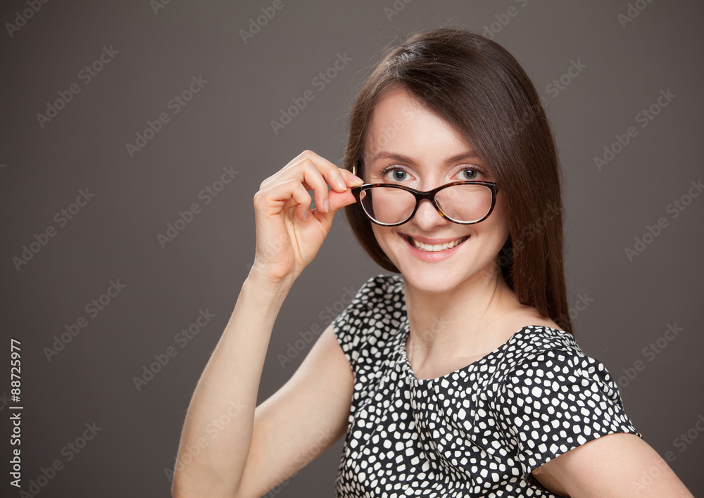 Portrait of a young woman in glasses, dark background Portrait of a young woman in glasses, dark background