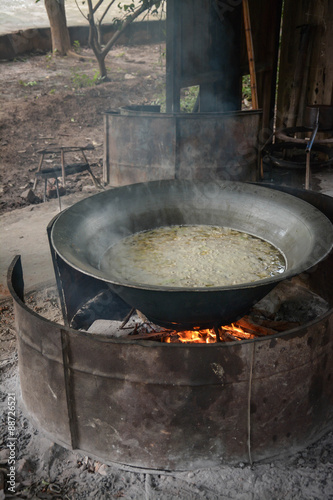 Cooking sliced cabbage soup in big pot on top of the stove