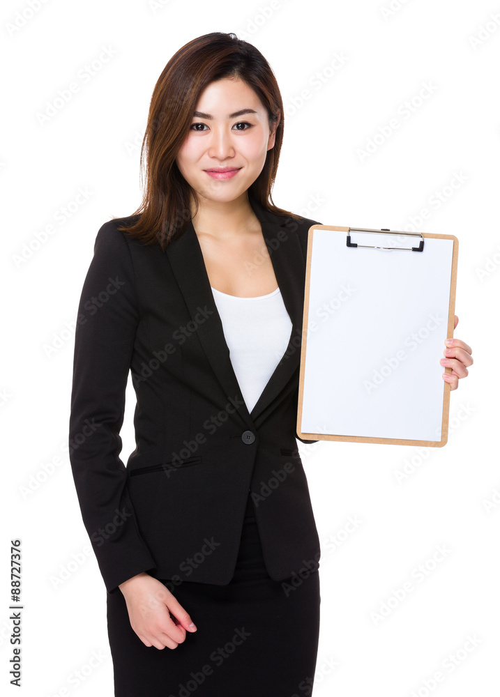 Businesswoman showing with blank page of clipboard Businesswoman showing with blank page of clipboard