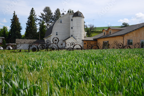 a barn with wheel fence photo