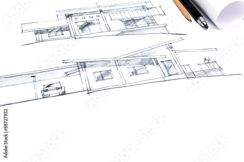 architect crayon sketches of a new house with pencils and paper rolls next to it
