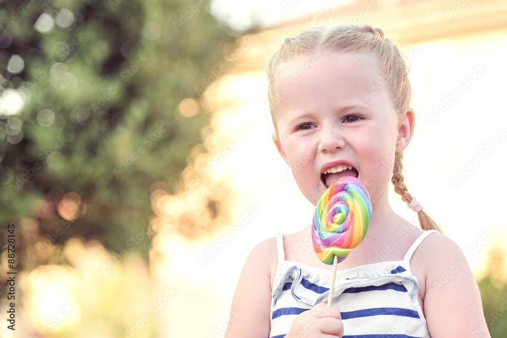 Beautiful blonde girl-tasting colored lollipop Beautiful blonde girl-tasting colored lollipop