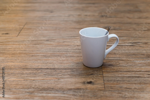 Empty white coffee mug on wooden table