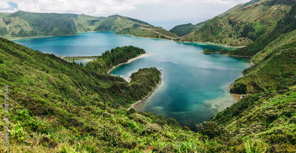 Panoramic view on Lagoa do Fogo, a crater lake within the Agua de Pau Massif stratovolcano in the center of the island of Sao Miguel in the Portuguese archipelago of the Azores.