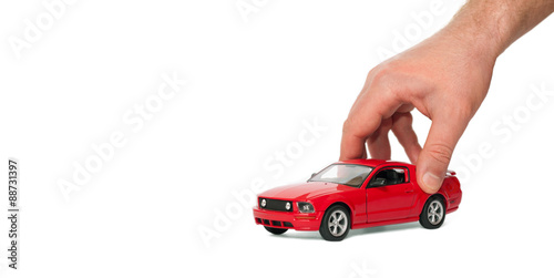 Red car in the men's hands on a white background