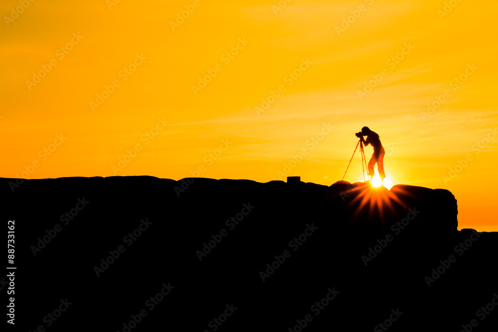 Silhouette of photographer at sunset.