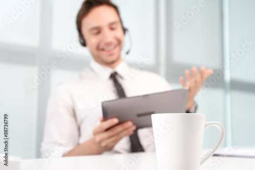 Call center operator holding laptop