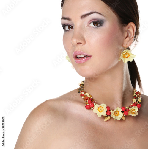 Portrait of young beautiful brunette woman in beads