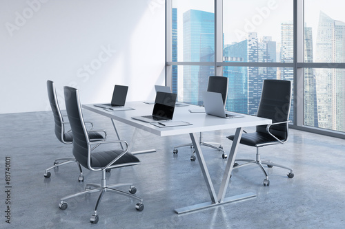 Modern meeting room with huge windows looking at Singapore business city. Black leather chairs and a white table with laptops. 3D rendering. © ImageFlow