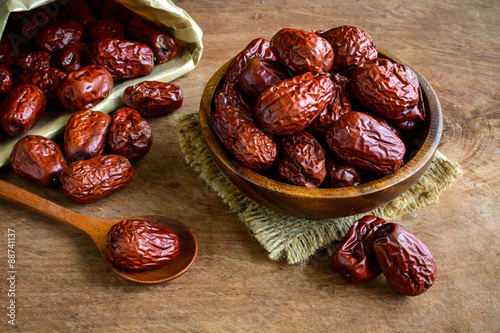 Dried jujube fruits on wooden table